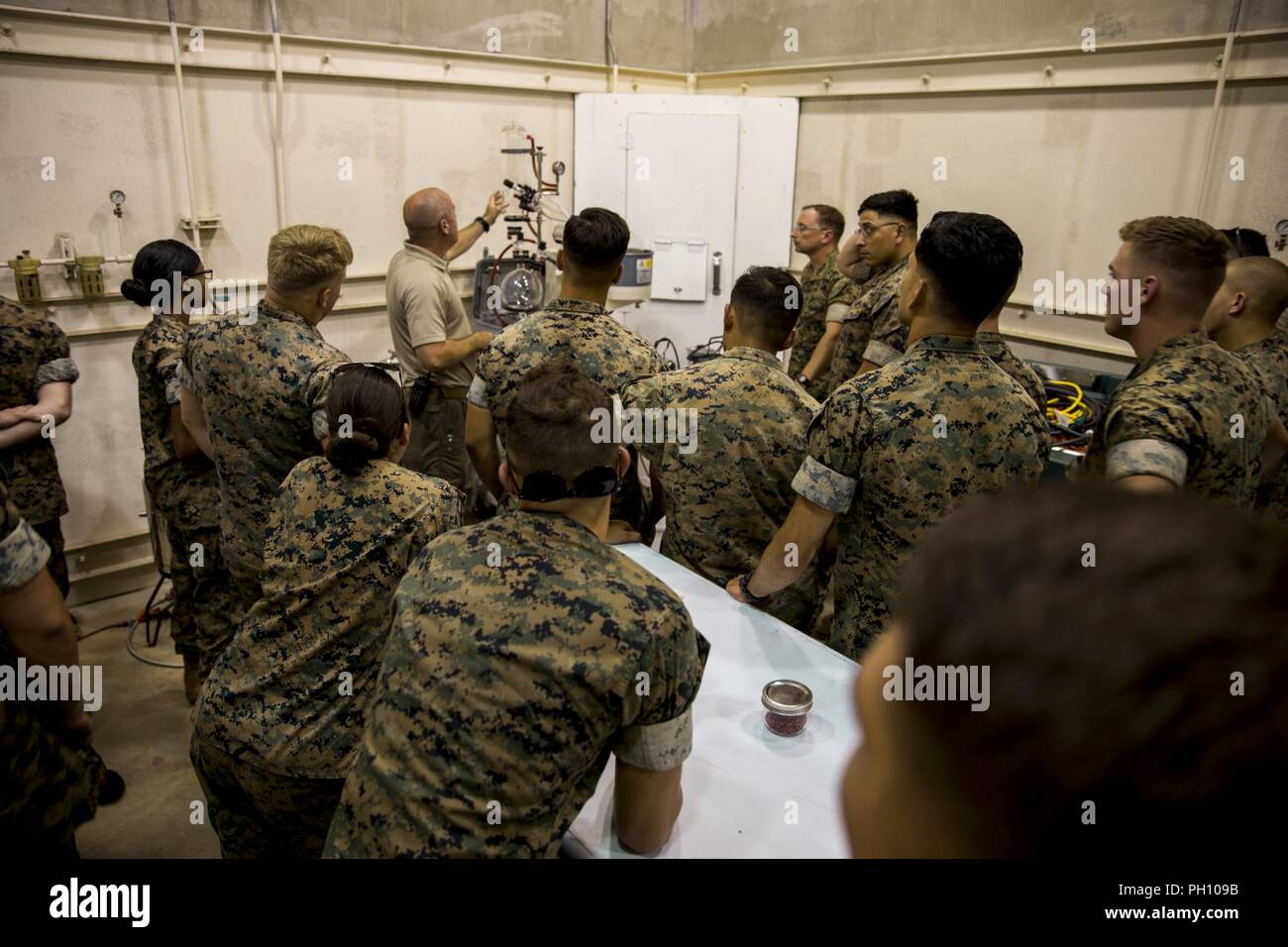 U.S. Marines with Chemical, Biological, Radiological, and Nuclear (CBRN) Platoon, Headquarters Battalion, 1st Marine Division, are briefed during the Concept of Real World CBRN Operations course at the Guardian Centers in Perry, Georgia, June 20, 2018. This training was conducted to enhance and refine the conduct of sensitive site exploitation, which supports the commander’s decision making cycle and maintains momentum during combat operations. Stock Photo