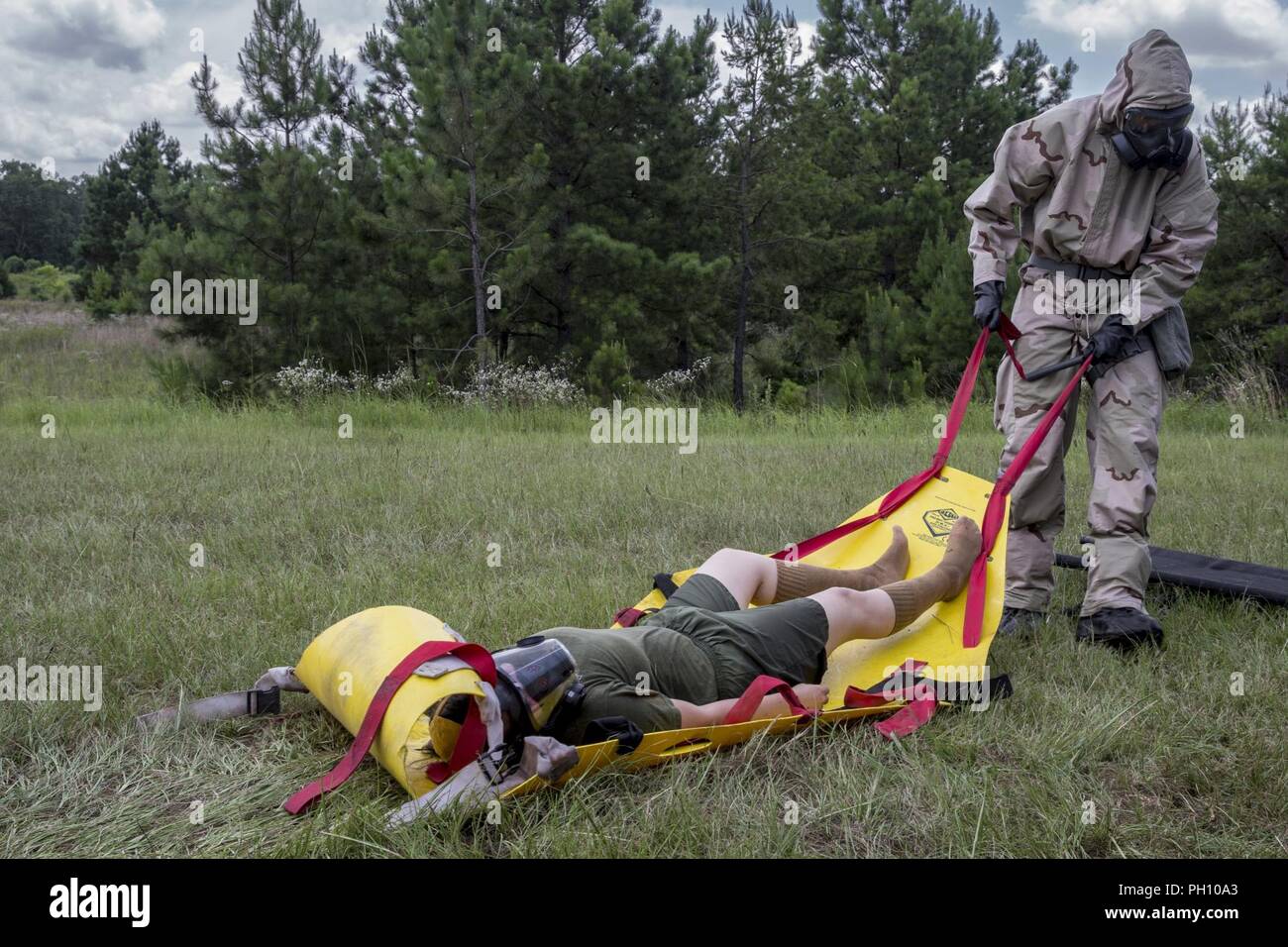 U.S. Marines with Chemical, Biological, Radiological, and Nuclear (CBRN) Platoon, Headquarters Battalion, 1st Marine Division, conduct casualty drills during the Concept of Real World CBRN Operations course at the Guardian Centers in Perry, Georgia, June 21, 2018. This training was conducted to enhance and refine the conduct of sensitive site exploitation, which supports the commander’s decision making cycle and maintains momentum during combat operations. Stock Photo