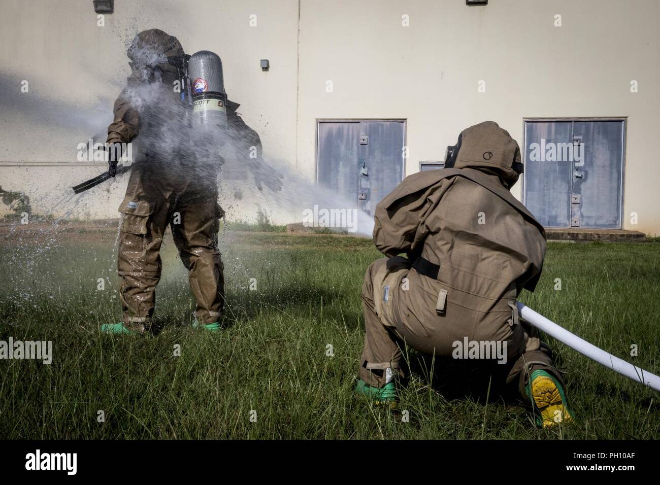 U.S. Marines with Chemical, Biological, Radiological, and Nuclear (CBRN) Platoon, Headquarters Battalion, 1st Marine Division, conduct decontamination drills during the Concept of Real World CBRN Operations course at the Guardian Centers in Perry, Georgia, June 22, 2018. This training was conducted to enhance and refine the conduct of sensitive site exploitation, which supports the commander’s decision making cycle and maintains momentum during combat operations. Stock Photo