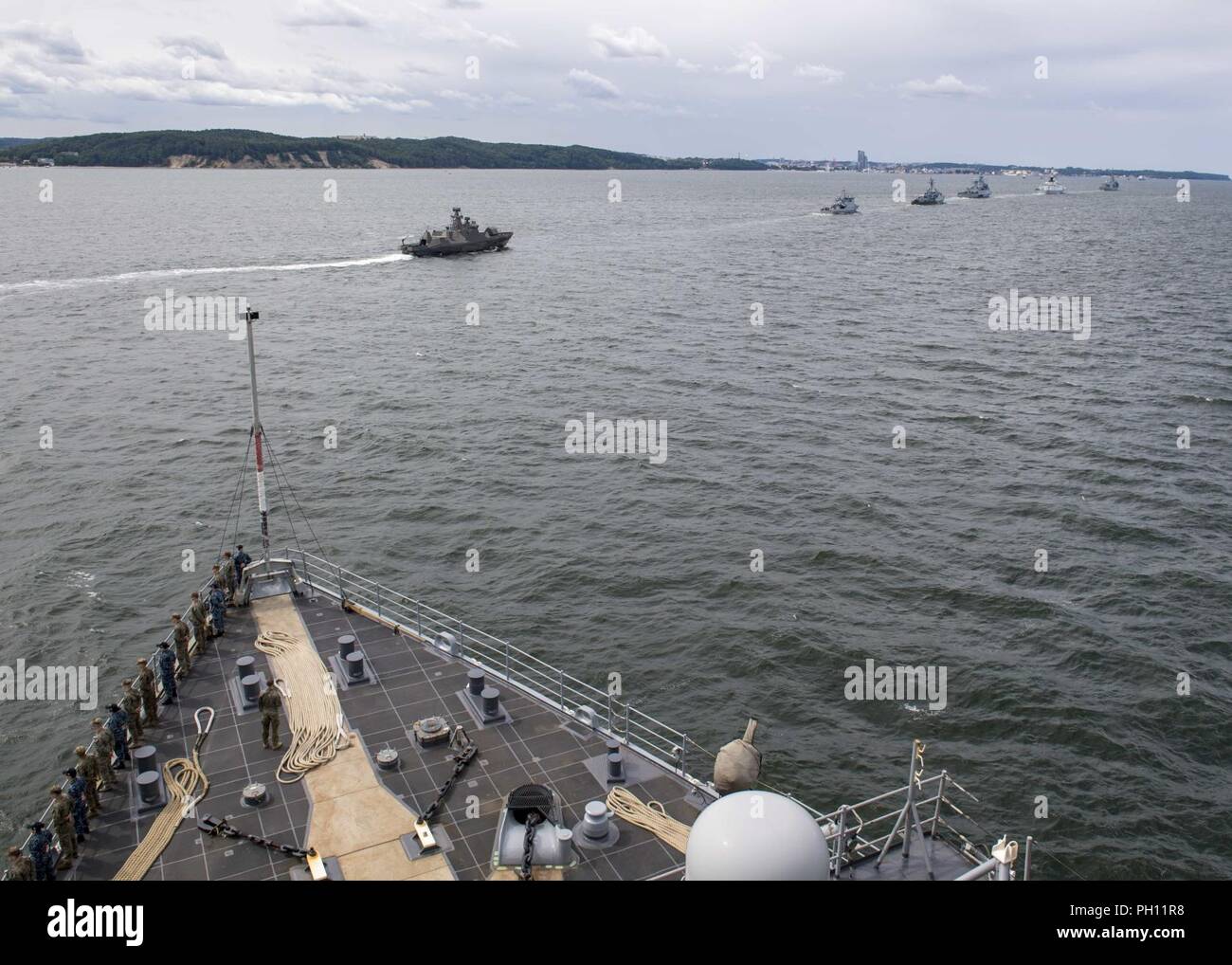 Poland (June 24, 2018) The Harpers Ferry-class dock landing ship USS Oak Hill (LSD 51) participates in a parade of ships in honor of Poland's 100-year naval anniversary, in Gdynia, Poland, June 24, 2018. Oak Hill, homeported in Virginia Beach, Virginia, is conducting naval operations in the U.S. 6th Fleet area of operations. Stock Photo
