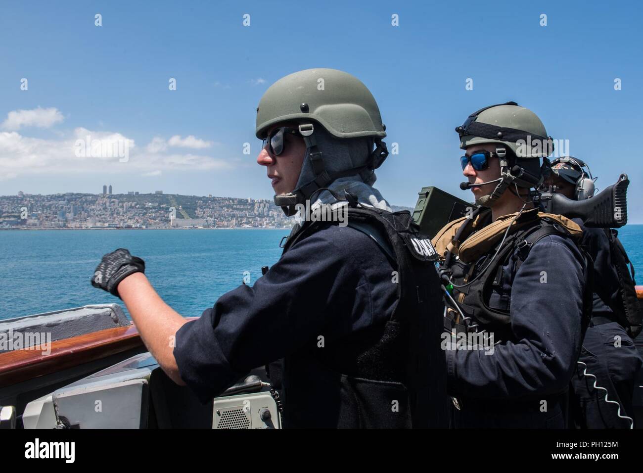 HAIFA, Israel (June 19, 2018) Lt. j.g. Elizabeth Warner, left, and Fire  Controlman 2nd Class Alexis Suarez, stand watch on the bridge wing of the  guided-missile destroyer USS Jason Dunham (DDG 109)