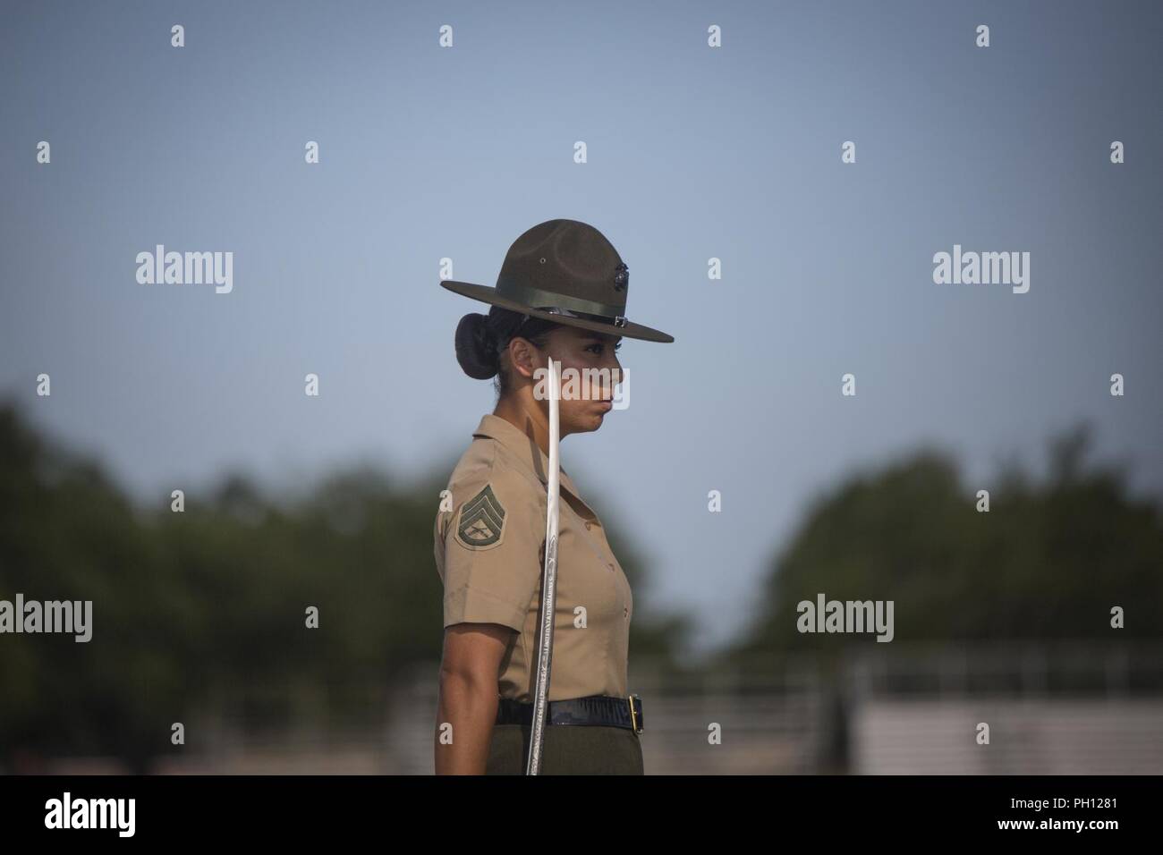 U.S. Marine Corps Drill Instructor Staff Sgt. Dalia Chavez prepares to give commands to Platoon 4030, Papa Company, 4th Recruit Training Battalion during an initial drill evaluation June 25, 2018, on Parris Island, S.C. Drill instructors are evaluated on their appearance, sword control and cadence during the evaluation. Papa Company is scheduled to graduate August 24, 2018. Parris Island has been the site of Marine Corps recruit training since Nov. 1, 1915. Today, approximately 19,000 recruits come to Parris Island annually for the chance to become United States Marines by enduring 13 weeks of Stock Photo