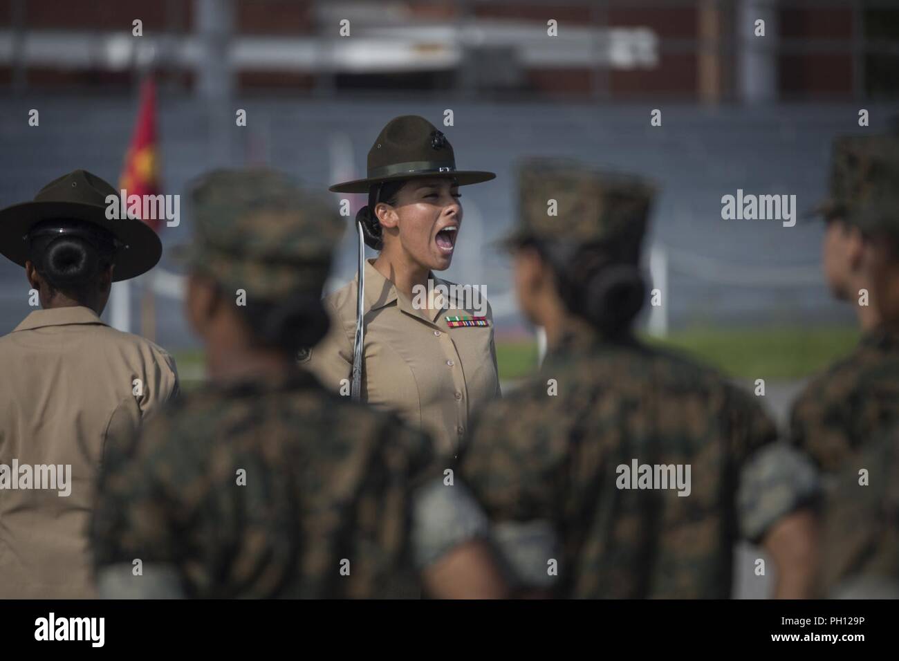 U.S. Marine Corps Drill Instructor Staff Sgt. Dalilah Chavez gives a command to Platoon 4030, Papa Company, 4th Recruit Training Battalion during an initial drill evaluation June 25, 2018, on Parris Island, S.C. Drill instructors, are evaluated on their appearance, sword control and cadence during the evaluation. Papa Company is scheduled to graduate August 24, 2018. Parris Island has been the site of Marine Corps recruit training since Nov. 1, 1915. Today, approximately 19,000 recruits come to Parris Island annually for the chance to become United States Marines by enduring 13 weeks of rigoro Stock Photo