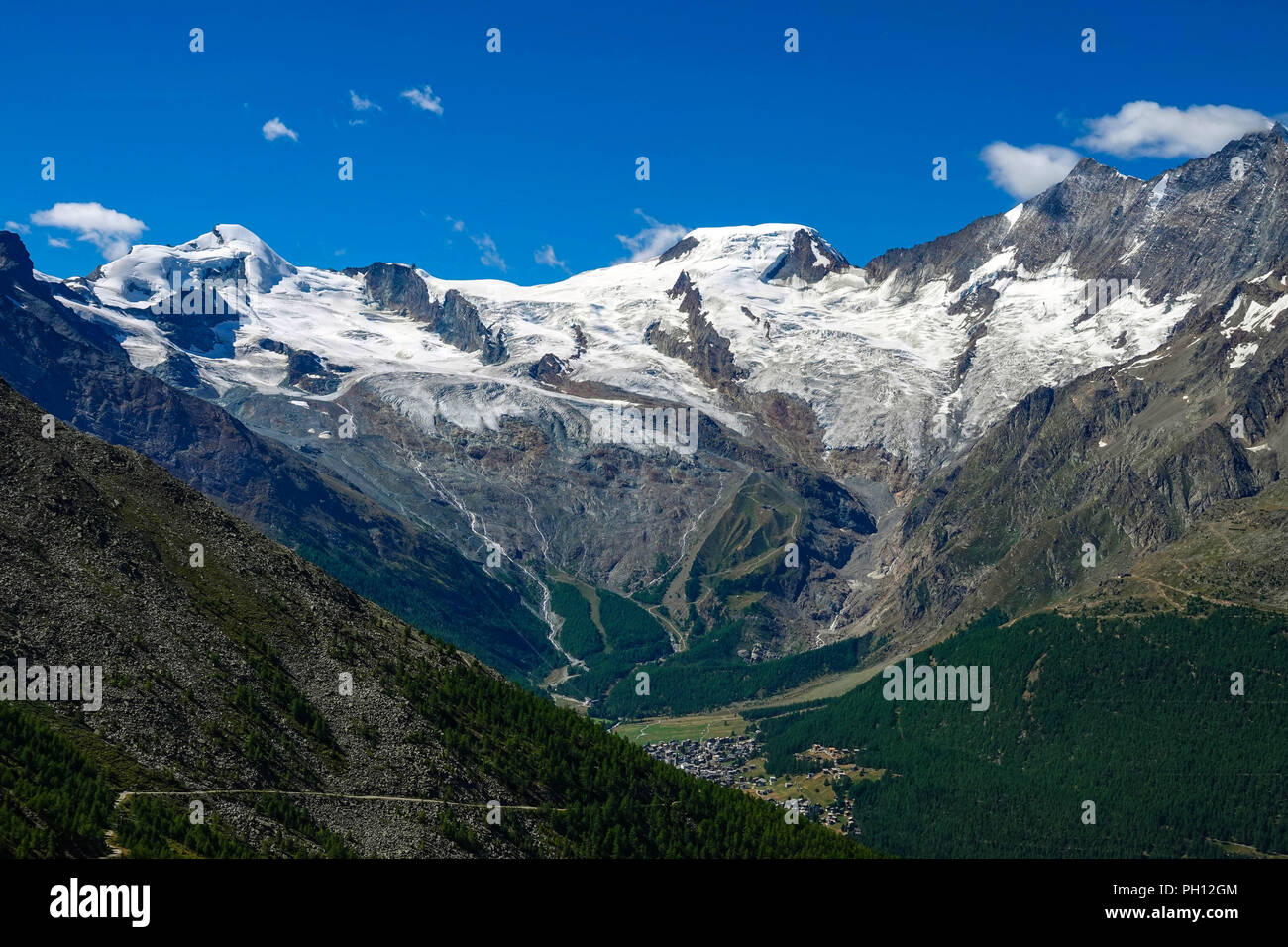 High Alpine peaks behind Saas Fee seen from Hohsaas cable car above Saas Grund, Switzerland Stock Photo