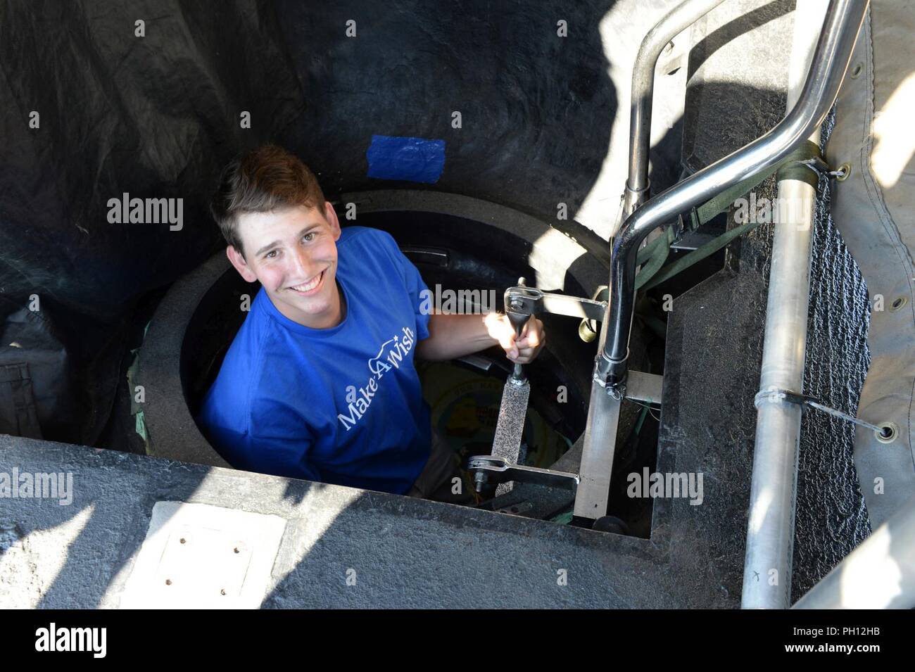 GROTON, Conn. (Jun. 19, 2018) Seventeen-year-old, Troy Perna, climbs down a vertical ladder during a tour aboard the Los Angeles class, fast-attack submarine, USS Hartford (SSN 768) during a tour arranged by the Make-A-Wish Foundation and Travelers Championship. The tour also included also included spending the day with professional golfer, Jordan Spieth during the Travelers Championship. The Make-A-Wish Foundation arranges experiences, or 'wishes', to children with life-threatening medical conditions from ages three to 17 years-old. Stock Photo