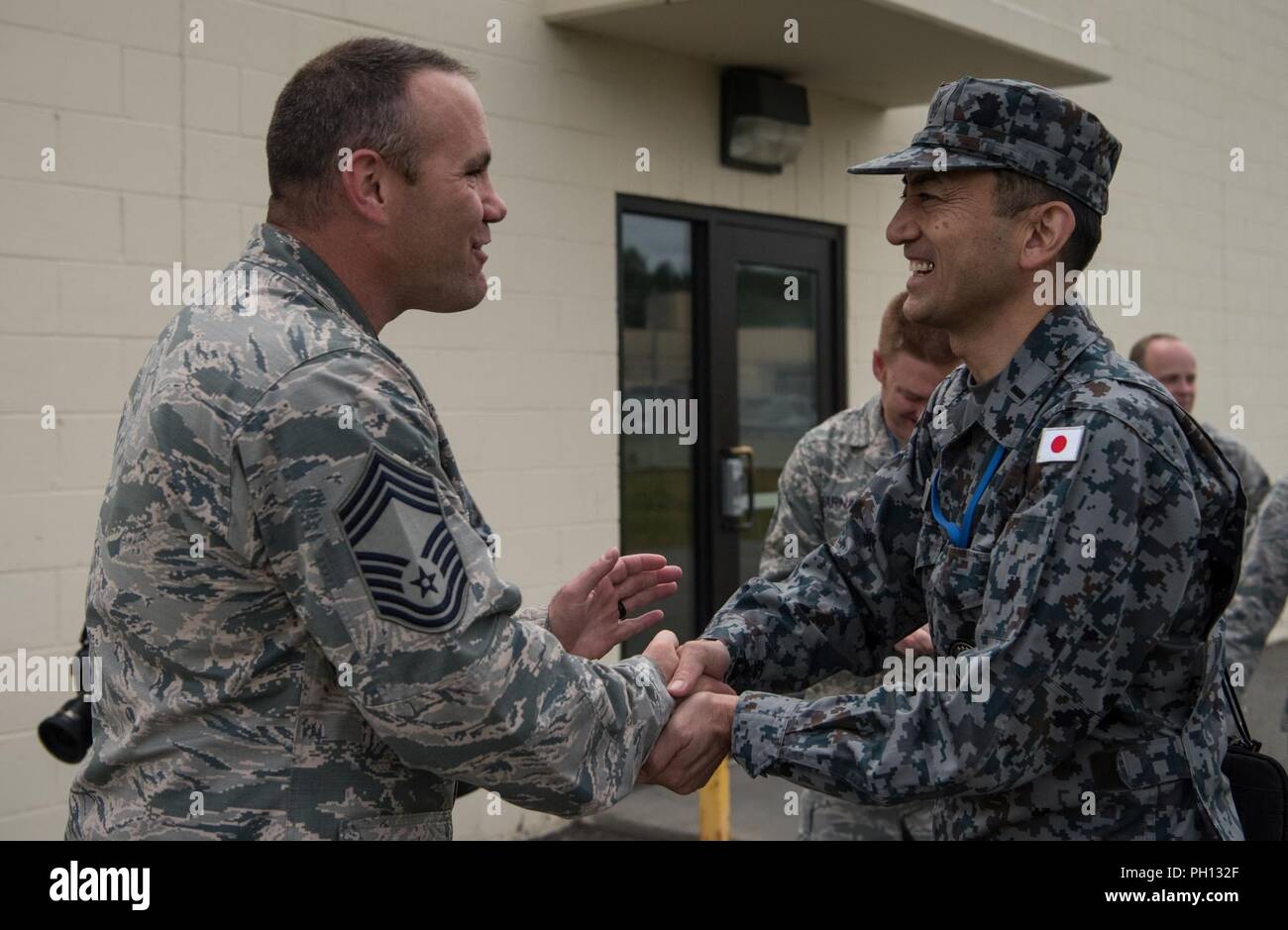 U.S. Air Force Chief Master Sgt. Mike Day, 962nd Airborne Air Control Squadron superintendent, says goodbye to Japan Air Self-Defense Force senior enlisted advisor Warrant Officer Masahiro Yokota at the end of a visit to Joint Base Elmendorf-Richardson, Alaska, June 19, 2018. During his visit, Yokota toured the installation and oversaw JASDF Airmen working alongside American forces during Pacific Air Forces’ premier air combat exercise, Red Flag-Alaska, iteration 18-2. Stock Photo