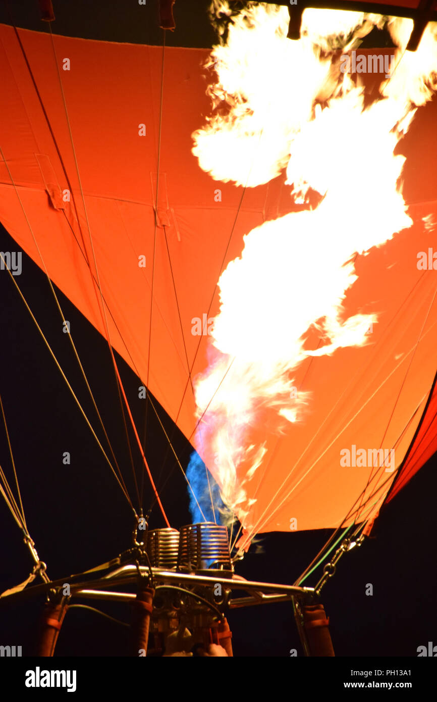 burner with a extreme hot flame light up the inside of a red hot air balloon, burner of a hot air balloon Stock Photo