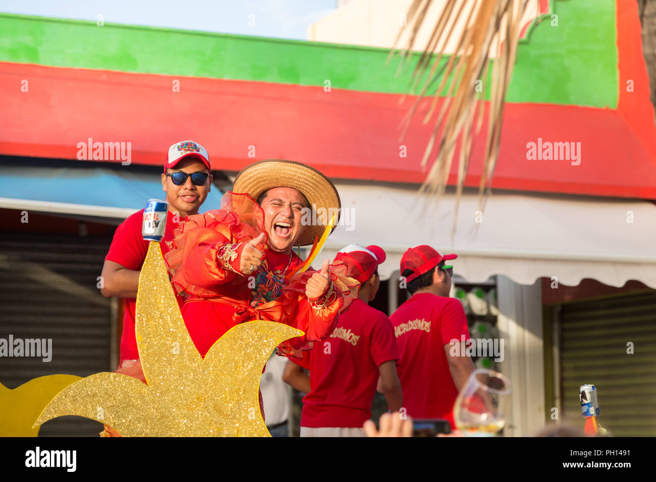 ISLA MUJERES, QR, MEXICO - FEB 11, 2018: Exuberant man performing on a float in a local celebration parade in the main town on Isla Mujeres. Stock Photo