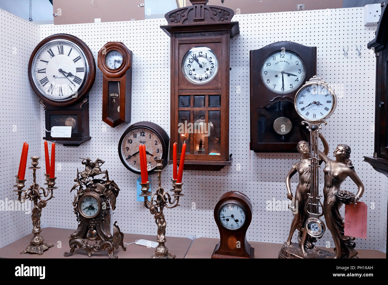 selection of antique clocks at a Bric-à-brac on display an English Antiques centre Stock Photo