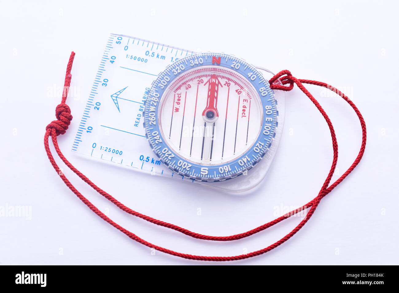 Adjustable compass with bezel and baseplate, needle pointing to magnetic north, on a white background Stock Photo