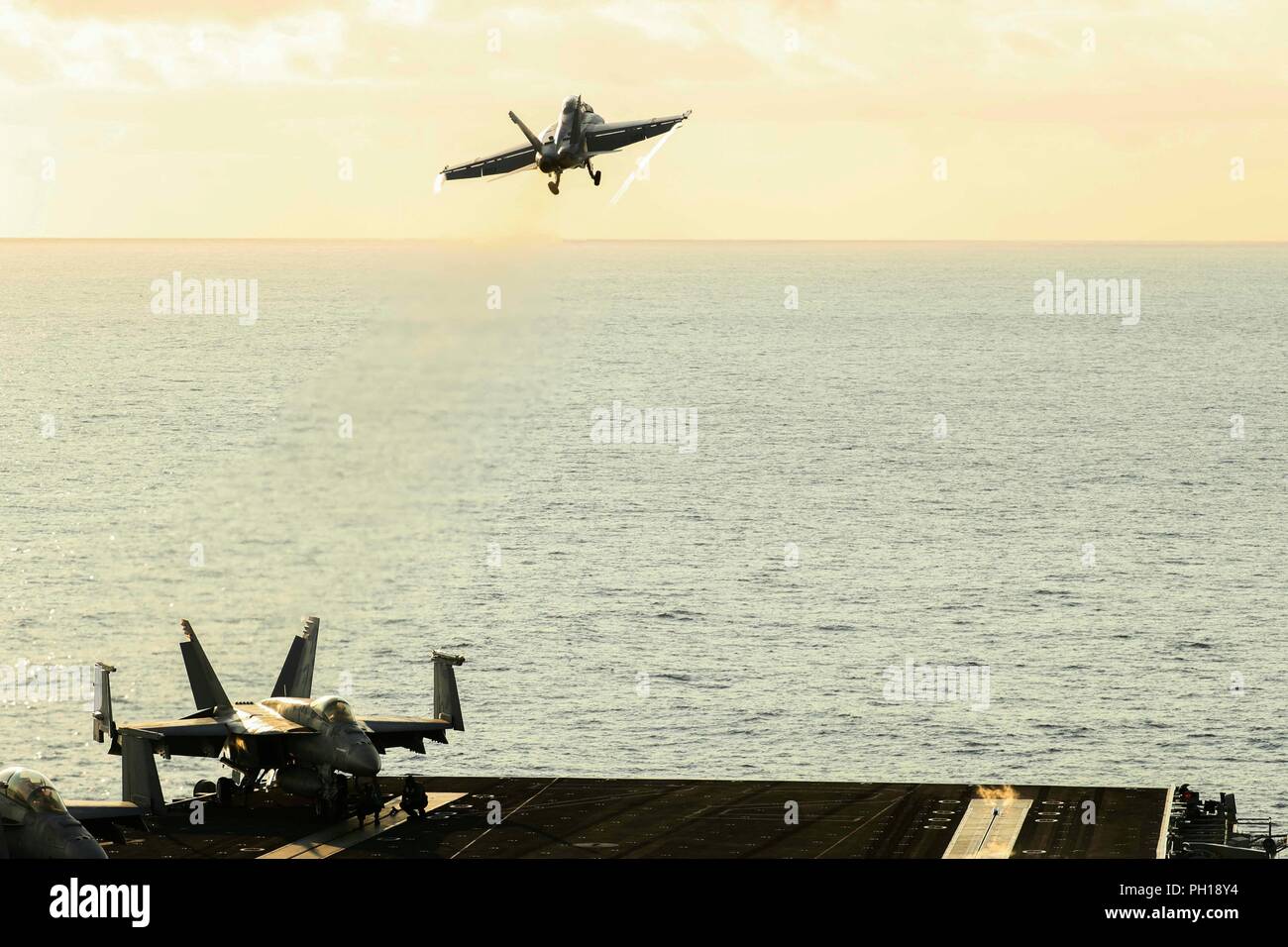 180824-N-FB291-1264 ATLANTIC OCEAN (Aug. 24, 2018) An F/A 18C Super Hornet from the Jolly Rogers of Strike Fighter Squadron (VFA) 200  launches from the flight deck of the Nimitz-class aircraft carrier USS Abraham Lincoln (CVN 72). (U.S. Navy photo by Mass Communication Specialist 3rd Class Garrett LaBarge/Released) Stock Photo
