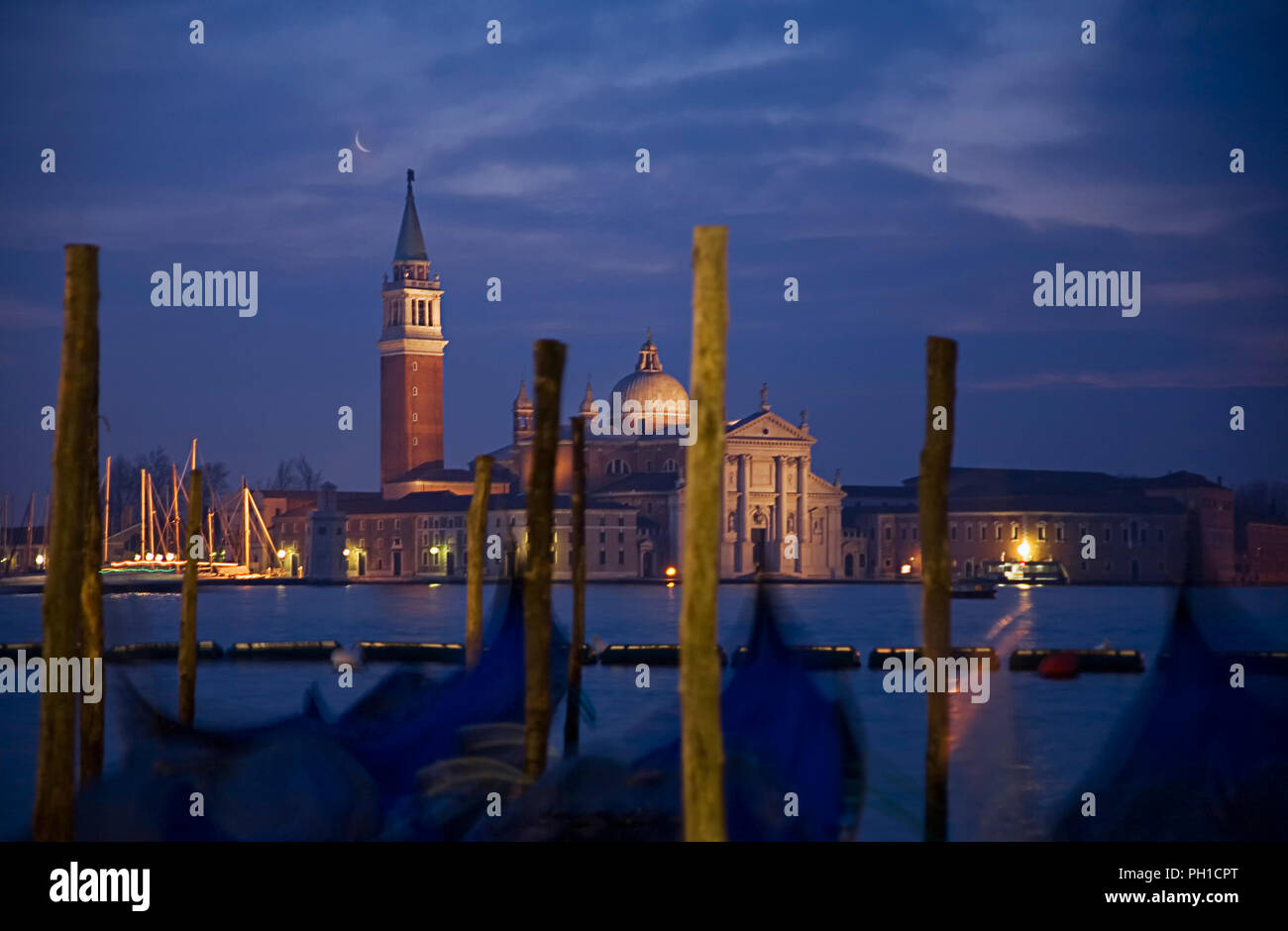 Chiesa di San Giorgio Maggiore, Venice, Italy, across the basin of St Mark at dawn: a line of moored gondolas in the foreground Stock Photo