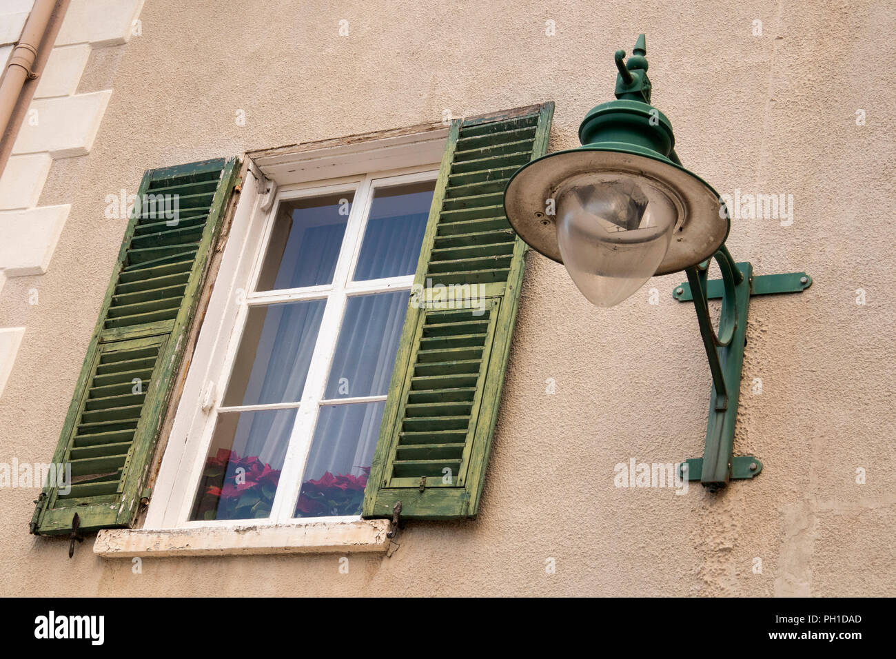 Gibraltar, Irish Town, old shuttered first floor window beside street light Stock Photo