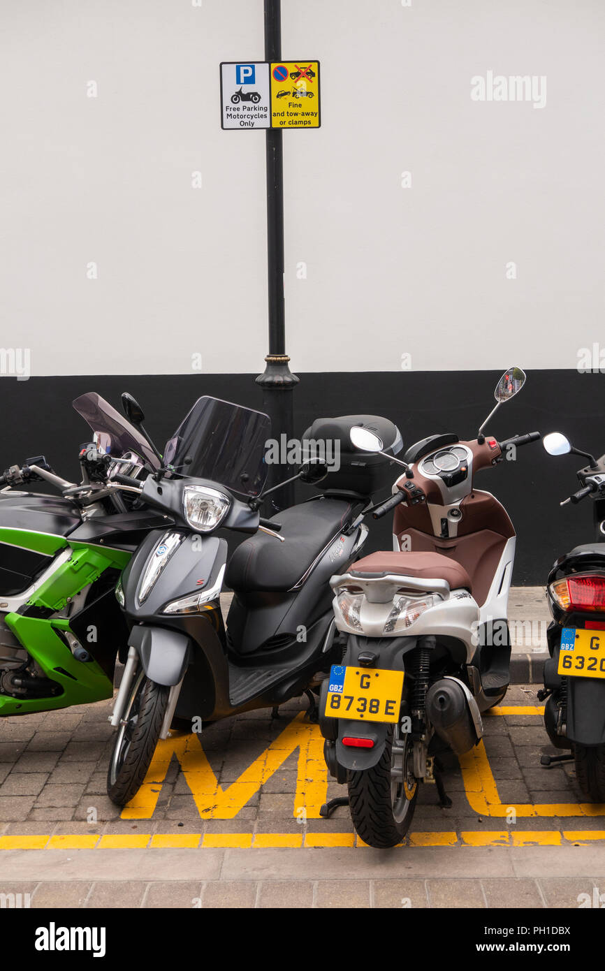 Gibraltar, Main Street, traffic, motorcycles parked in dedicated free parking area Stock Photo