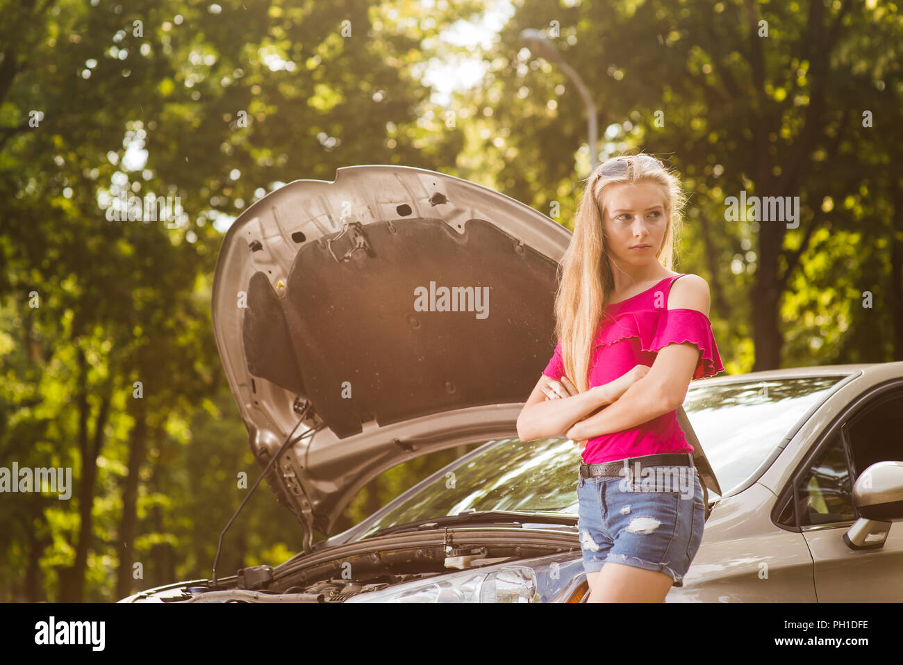 Attractive young female with broken car with open hood Stock Photo - Alamy