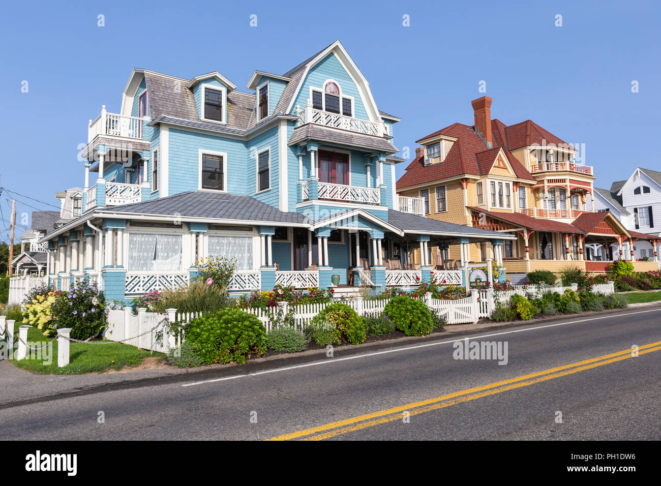 Colorfully painted Victorian houses, including the Oak House, serve as B&Bs on Seaview Avenue in Oak Bluffs Massachusetts on Martha's Vineyard. Stock Photo