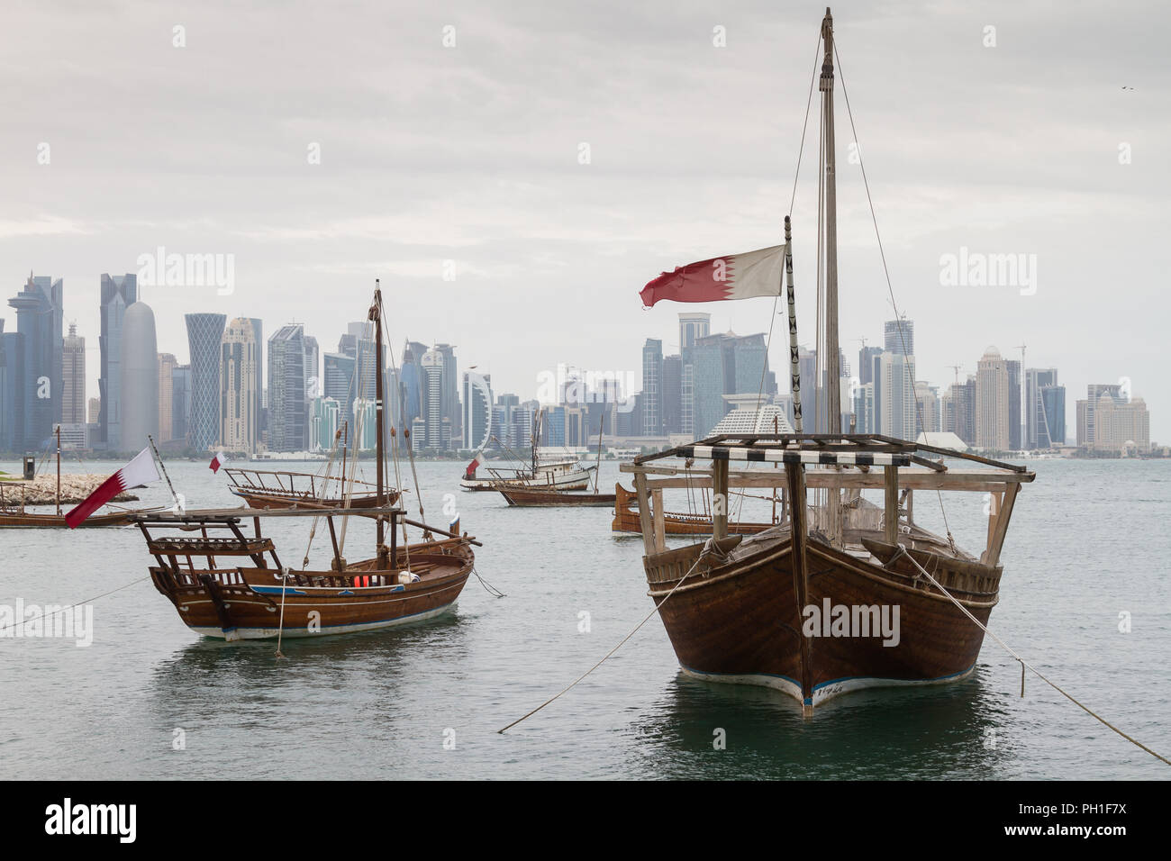 Arabic Dhows in front of the skyline of Doha Stock Photo