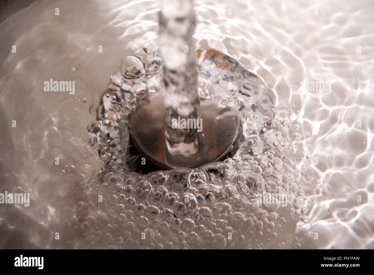 Water splashing down the sink. Scene water splashing pouring strong of