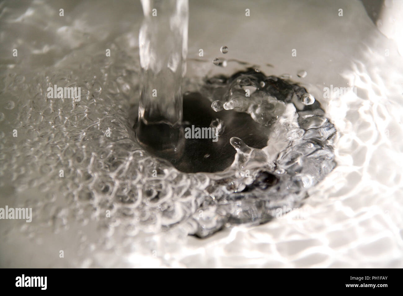 Water splashing down in the sink, close up. Scene water splashing