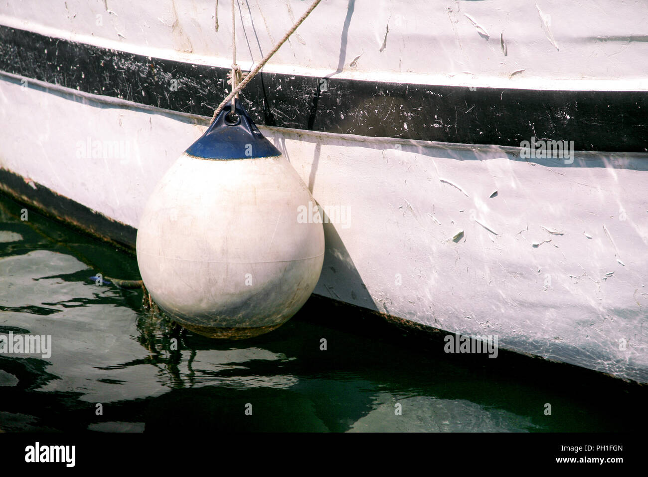 Buoys and anchor ropes, close up. White buoys and anchor ropes on