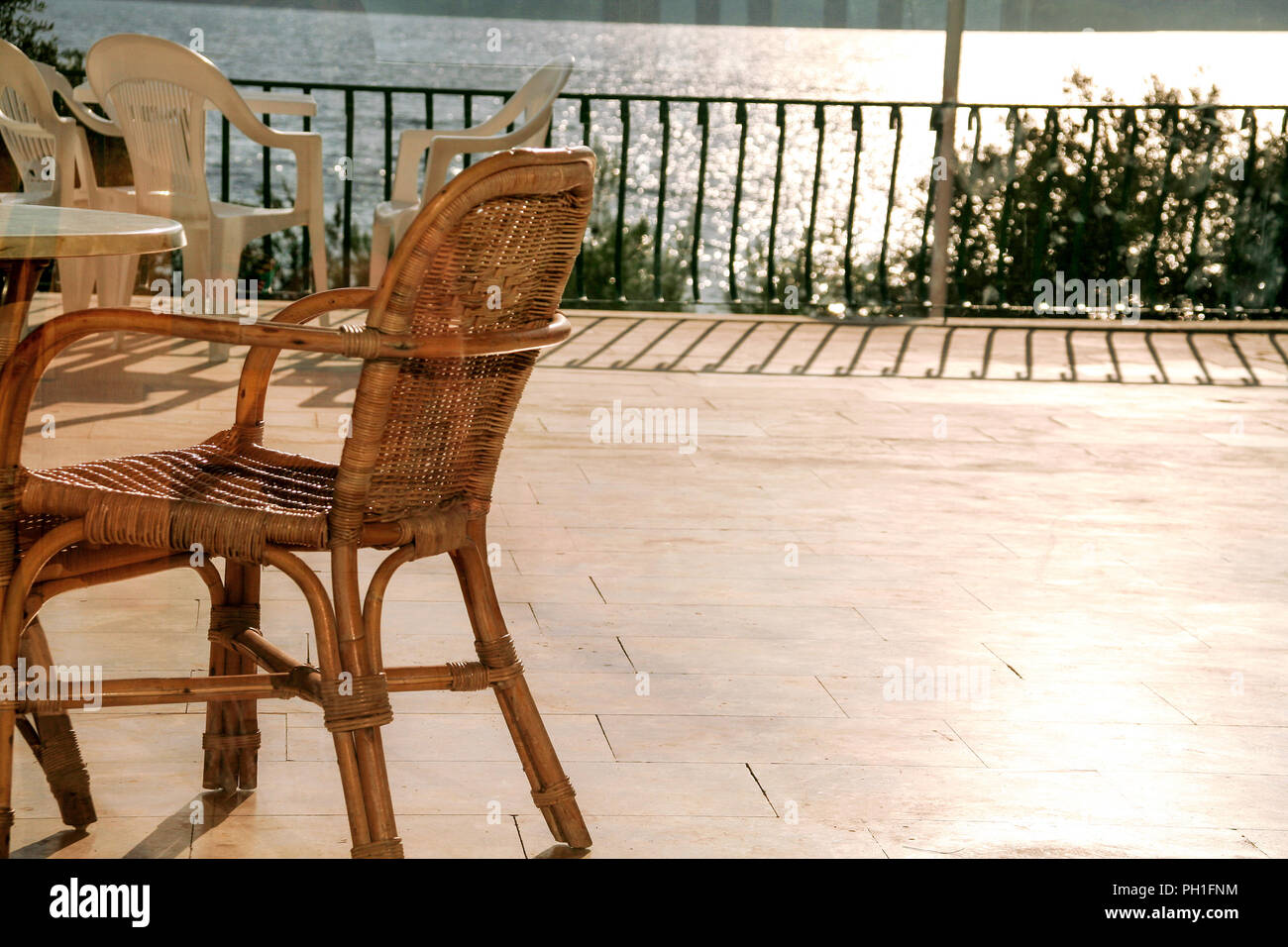 Table and chairs on a balcony on the beach hires stock photography and