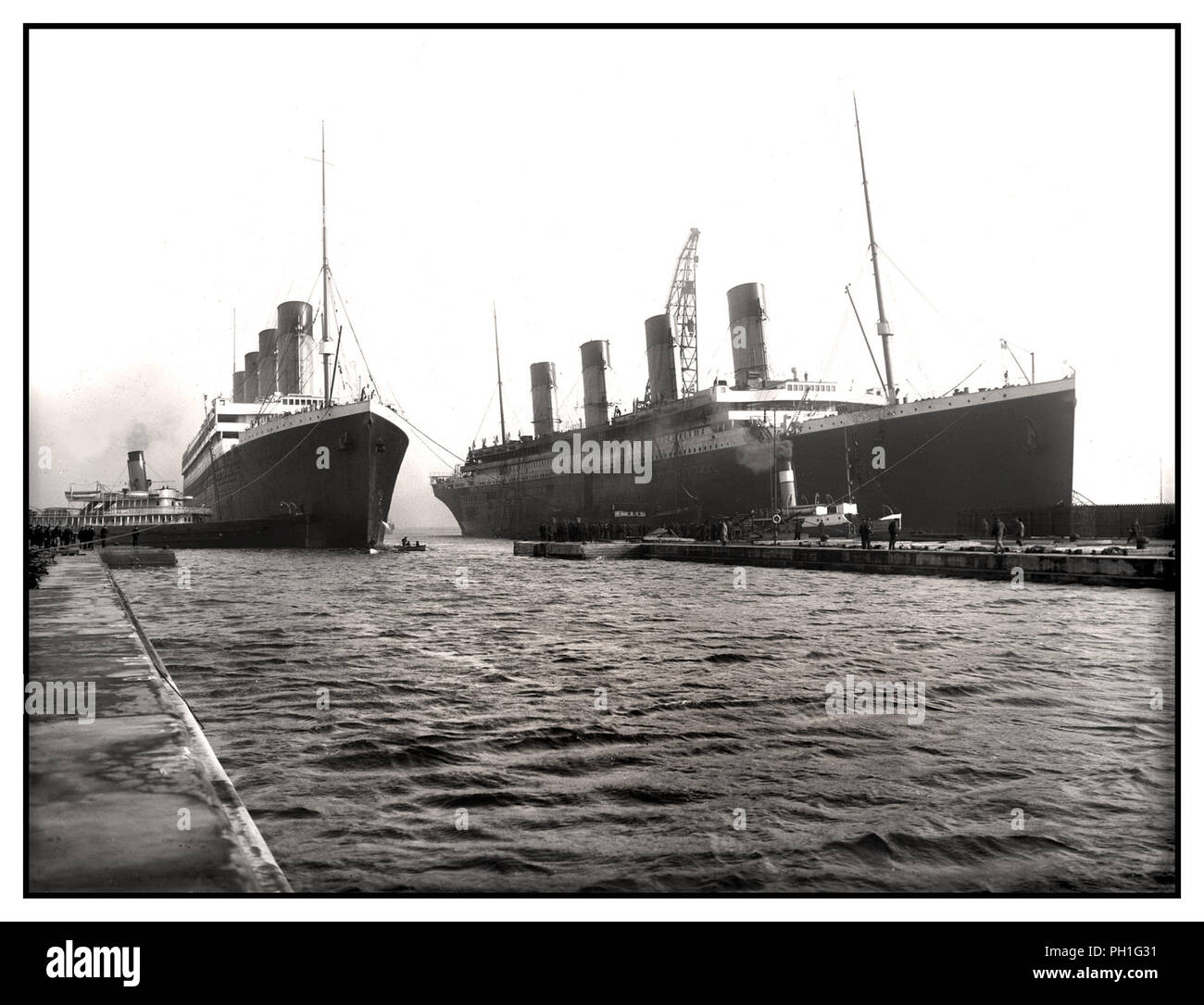 TITANIC & OLYMPIC sister ocean liners Vintage B&W RMS Olympic entering  Belfast docking harbour alongside with RMS Titanic undergoing final  preparations March 1912, for her fateful maiden voyage on 14th April 1912