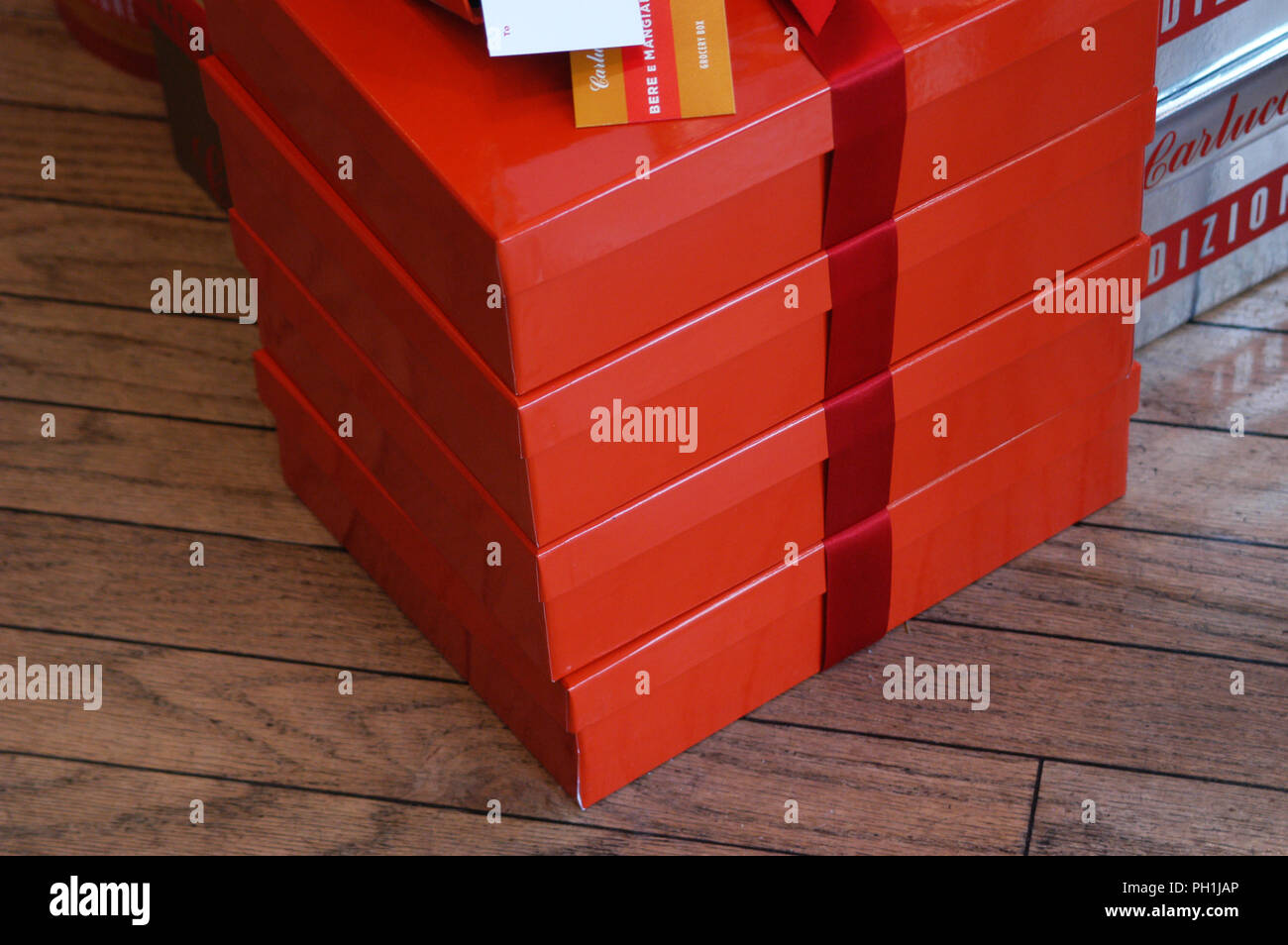 Side view of simple coloured gift boxes arranged in a pile. Seen here