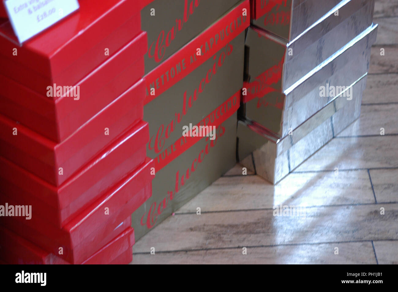 Side view of simple coloured gift boxes arranged in a pile. Seen here