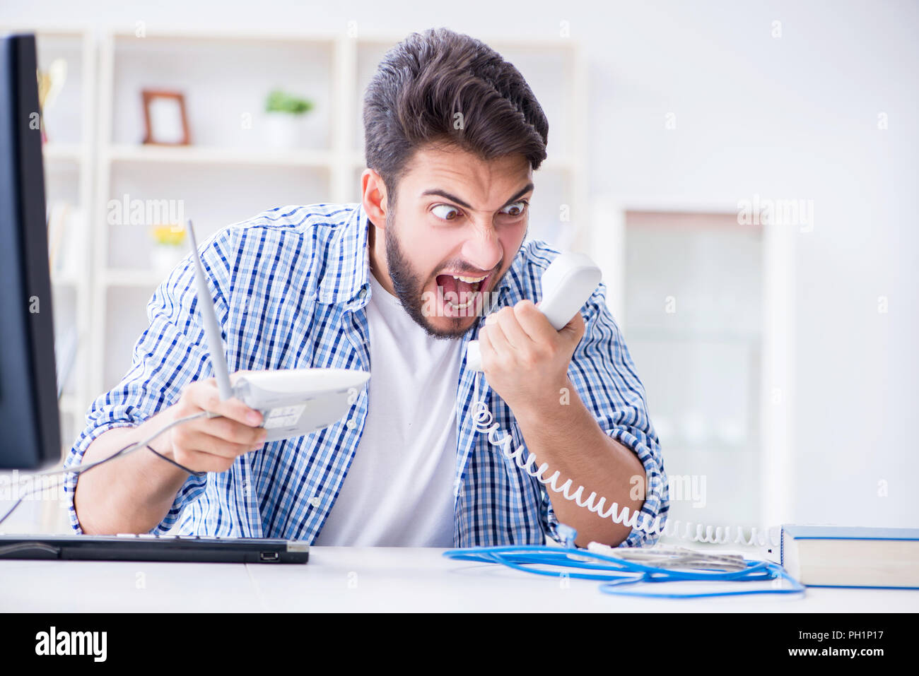Frustrated young man due to weak internet reception Stock Photo - Alamy