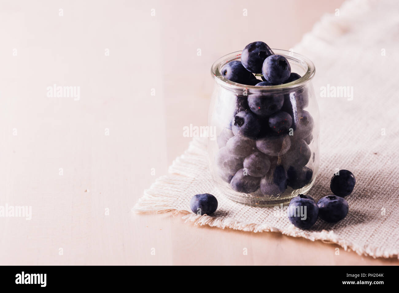 Close view of fresh blueberries in a glass jar Stock Photo