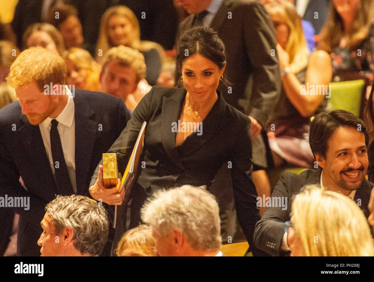 The Duke and Duchess of Sussex take their seats next to Lin Manuel Miranda at the Victoria Palace Theatre in London, to see a gala performance of the musical Hamilton, in support of Sentebale. Stock Photo