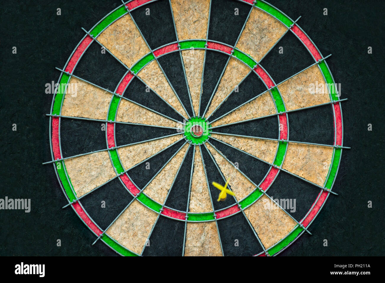 Target dart board on the black background, center point, head to target