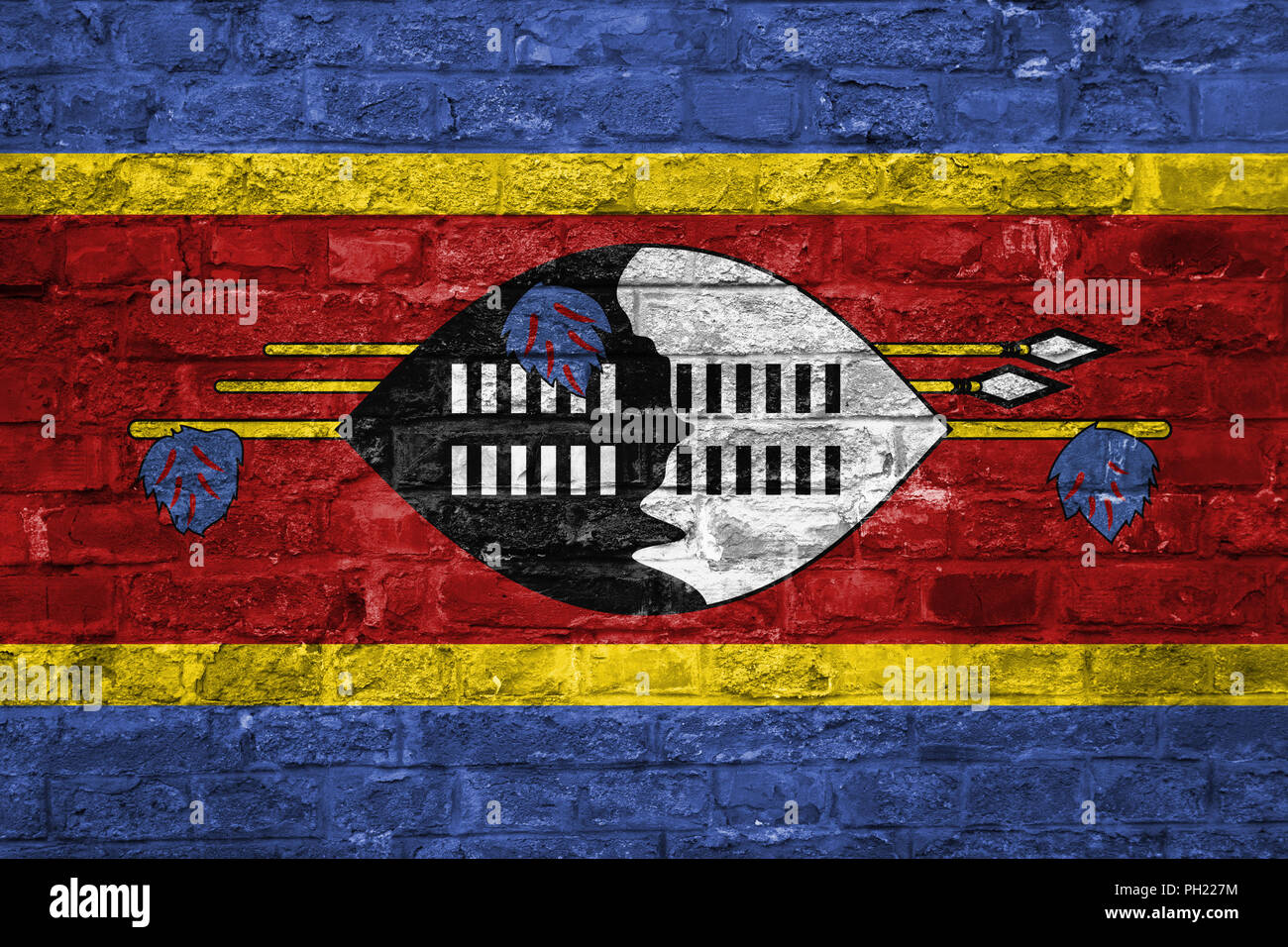 Flag of Swaziland over an old brick wall background, surface Stock