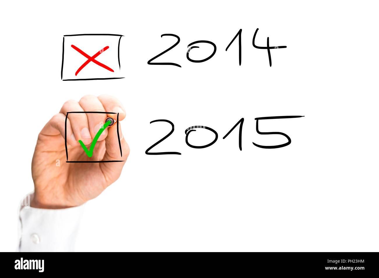 Man ticking the start of the 2015 New Year with a green tick in a check box as he crosses off the date for 2014 as the year draws to an end, hand-draw Stock Photo