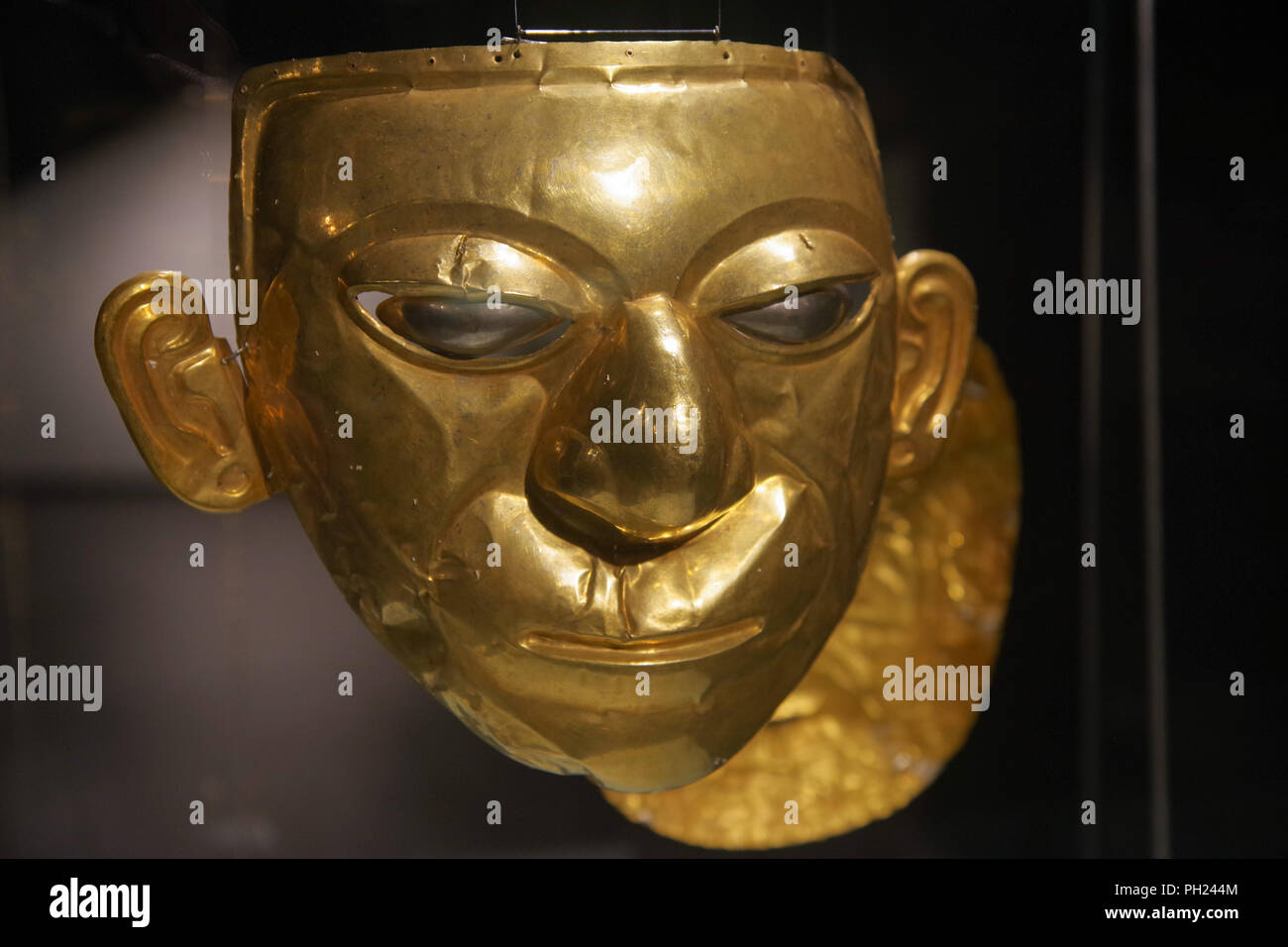 QUITO, ECUADOR - AUGUST 24, 2018: Close up of beautiful golden Inca face inside of el Agora museum located in Casa de la Cultura in Quito Ecuador. Stock Photo