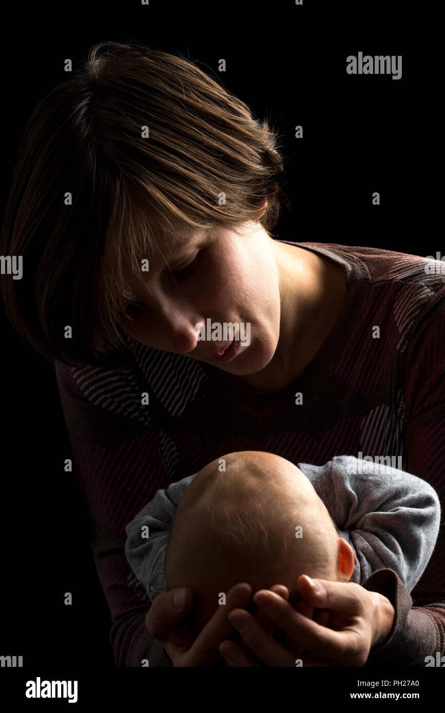Mother cradling baby portrait hires stock photography and images Alamy