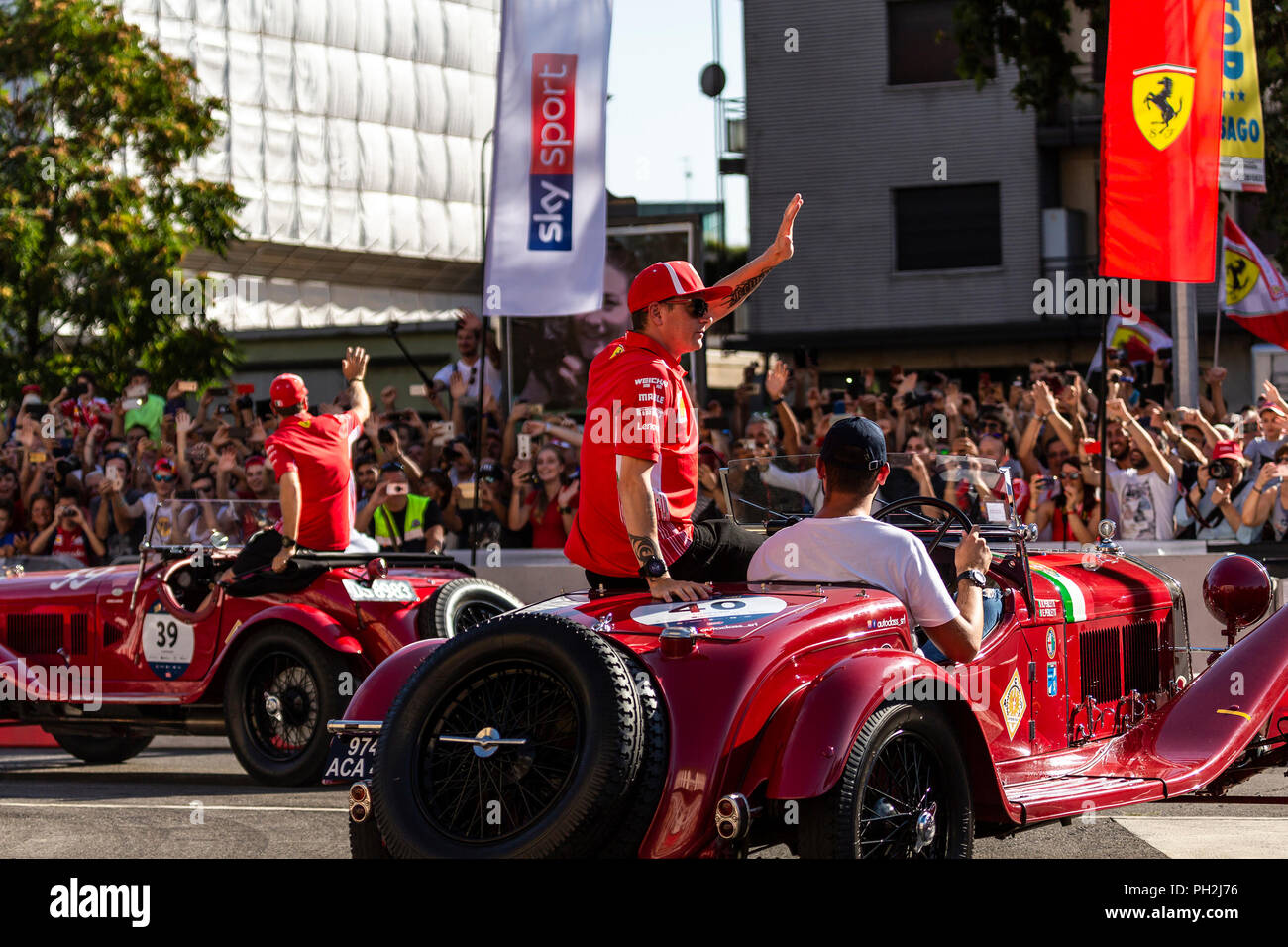 Milan, Italy, 29th August 2018 - Kimi Raikkonen and Sebastian Vettel from Ferrari F1 Team greet the fans during the Divers Parade at F1 Milan Festival - Valeria Portinari Alamy Live News Stock Photo