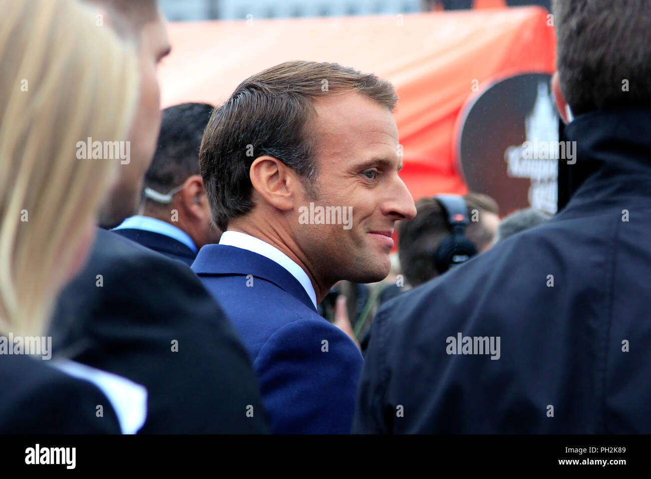 Helsinki, Finland. August 30, 2018. French President Emmanuel Macron (C)  and Finnish President Sauli Niinistö (not in picture) take a walk on the  Market Square after their joint press conference. Credit: Taina