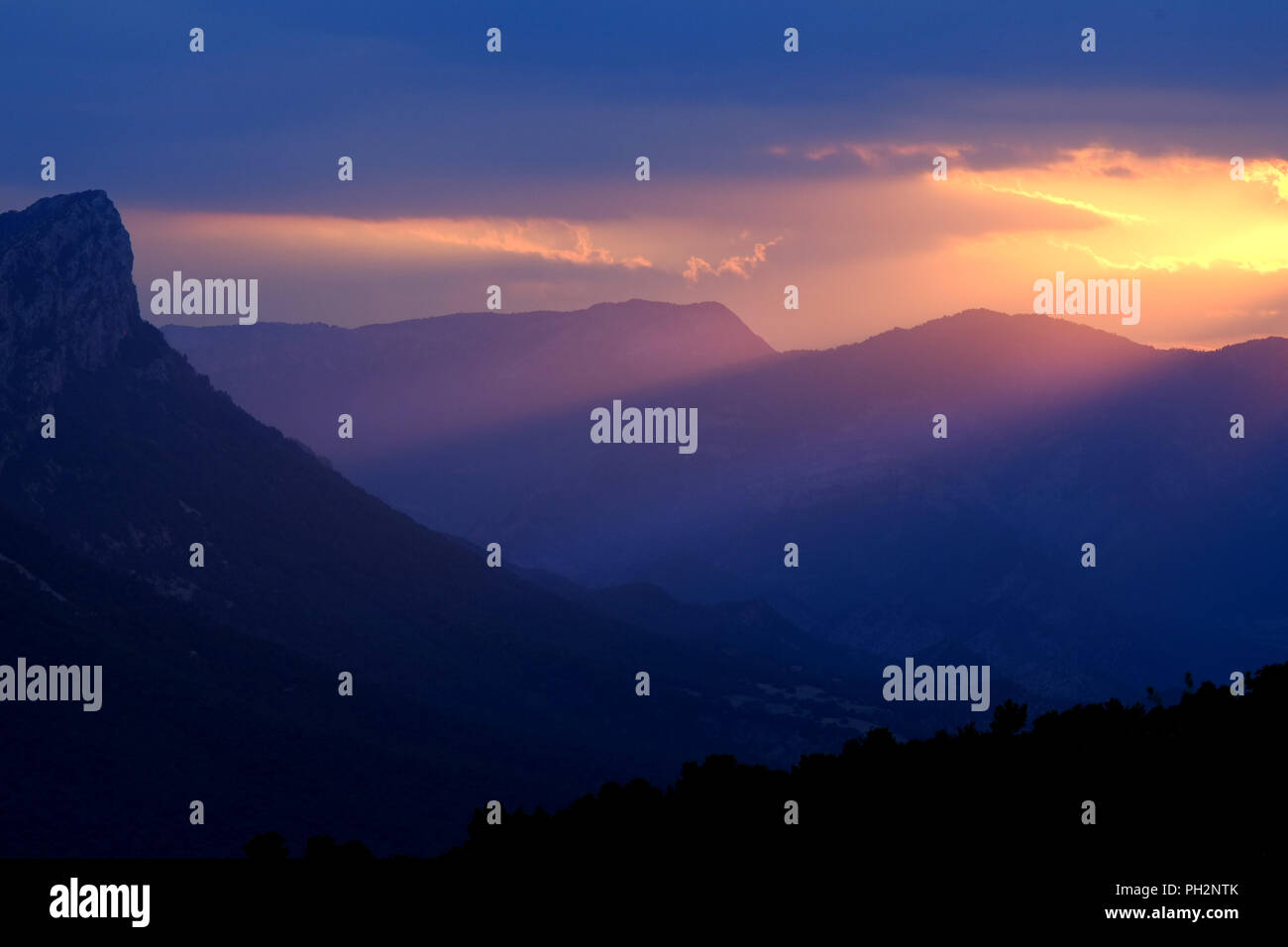 Hazy mountain landscape with sun rays, Spanish Pyrenees, Catalonia. Stock Photo