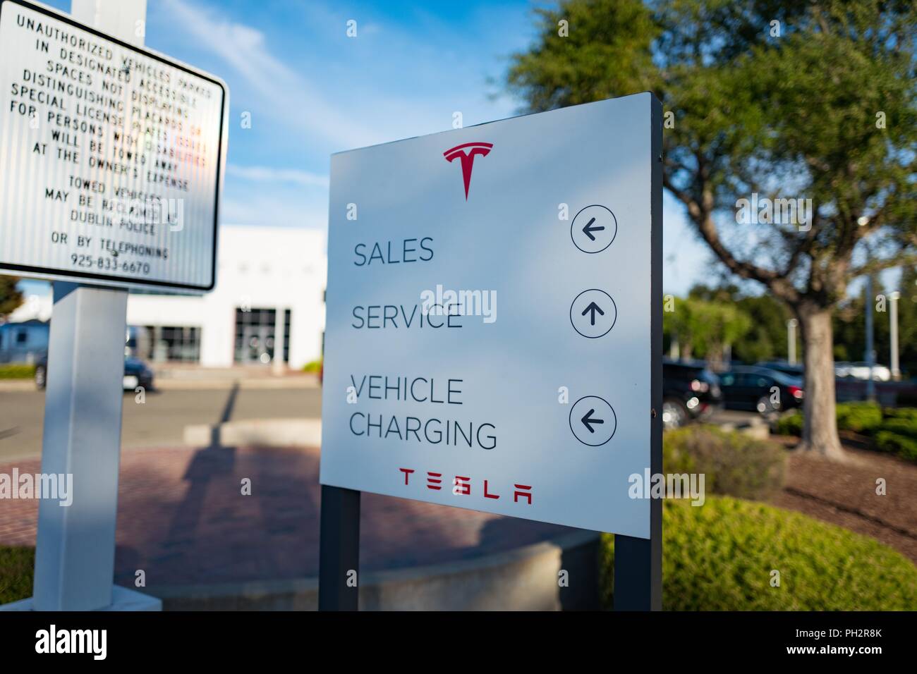 Sign at Tesla Motors dealership in Pleasanton, California, identifying Sales, Service and Vehicle Charging, July 23, 2018. () Stock Photo