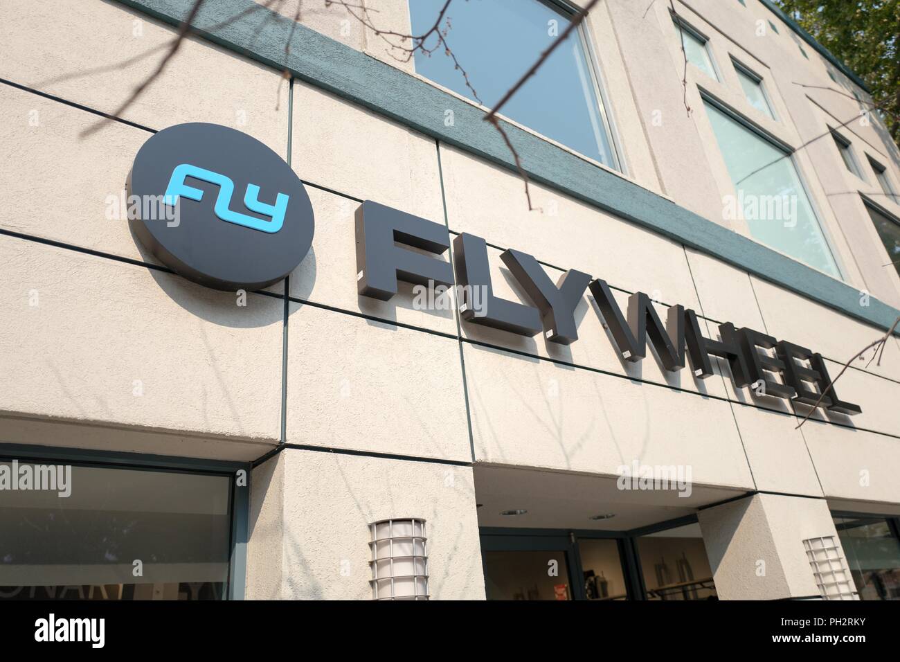 Sign with logo on facade of Flywheel Sports, an upscale indoor cycling gym in the San Francisco Bay Area town of Walnut Creek, California, August 6, 2018. () Stock Photo