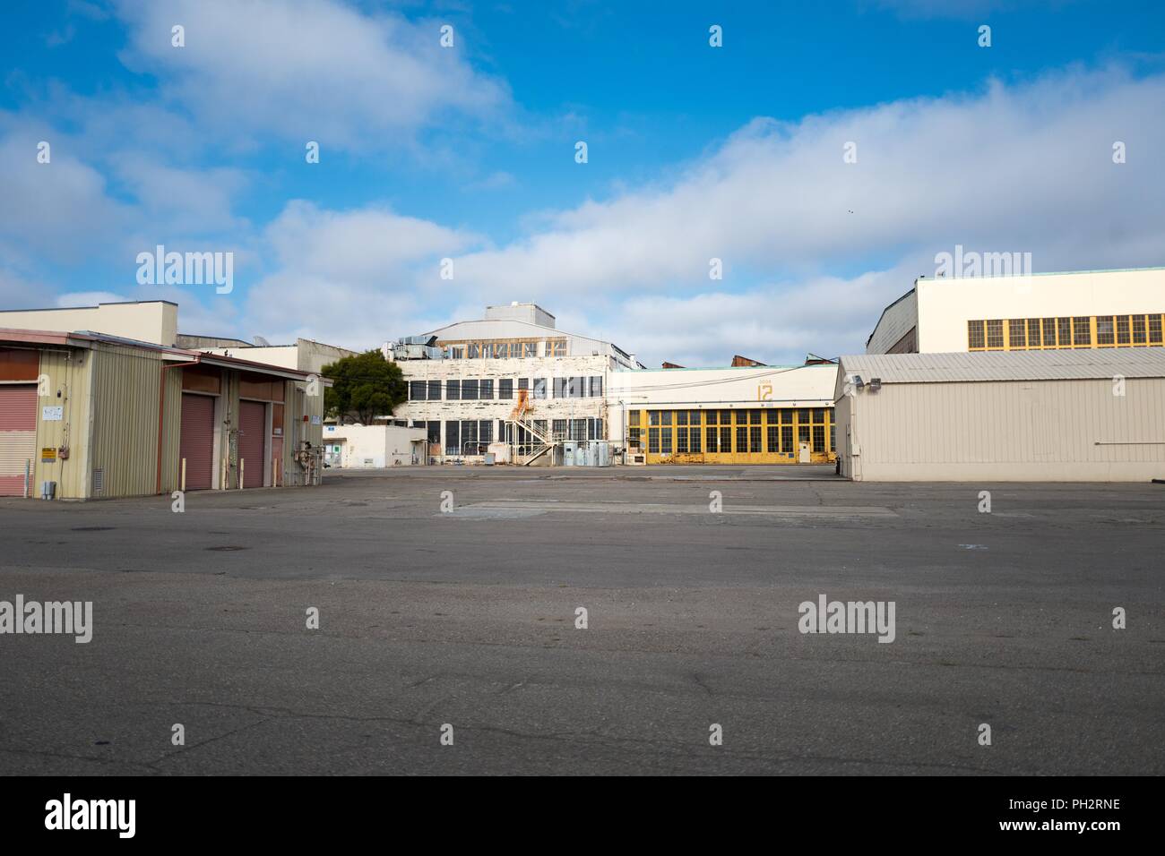 Hangar buildings are visible across a large stretch of tarmac at the defunct Alameda Naval Air Station (NAS), a former US Navy base on Alameda Island, Alameda, California, August 13, 2018. () Stock Photo