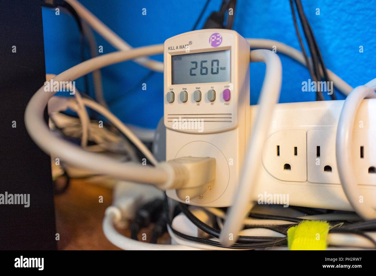 Close-up of maze of wires and Kill-A-Watt electric use monitor showing the power consumption of a computer engaged in cryptocurrency mining; electric monitors are commonly used by miners to monitor the profitability of their mining operations, August 21, 2018. () Stock Photo