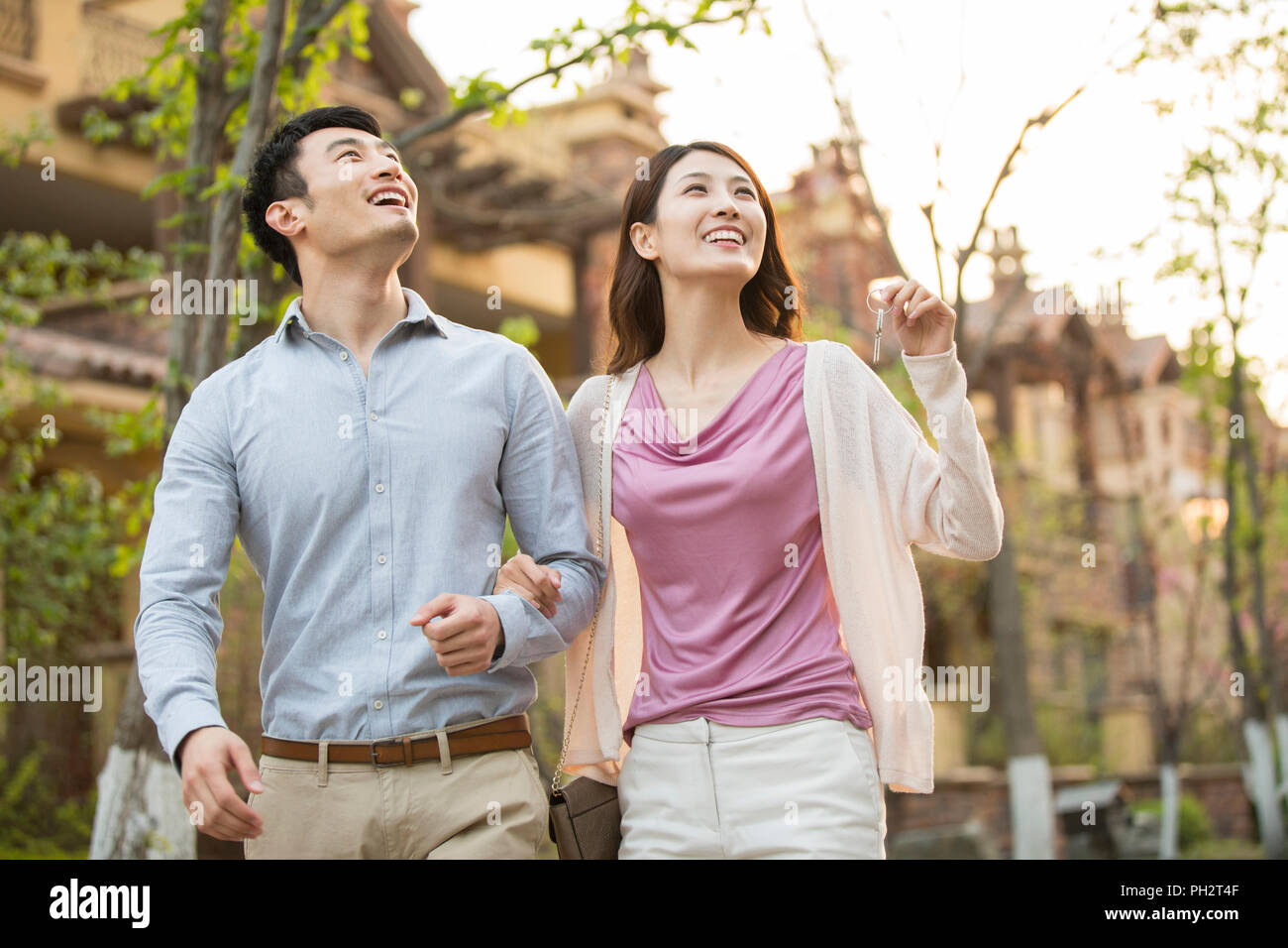 Happy young couple holding keys to new house Stock Photo - Alamy
