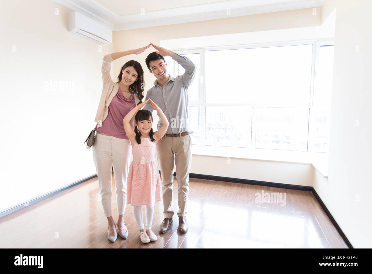 Happy young family in their new house Stock Photo - Alamy