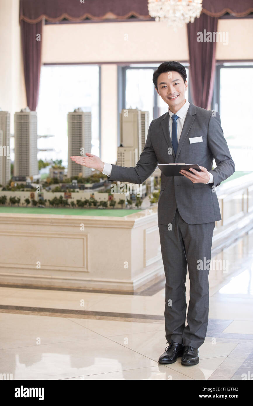 Confident realtor in sales center Stock Photo