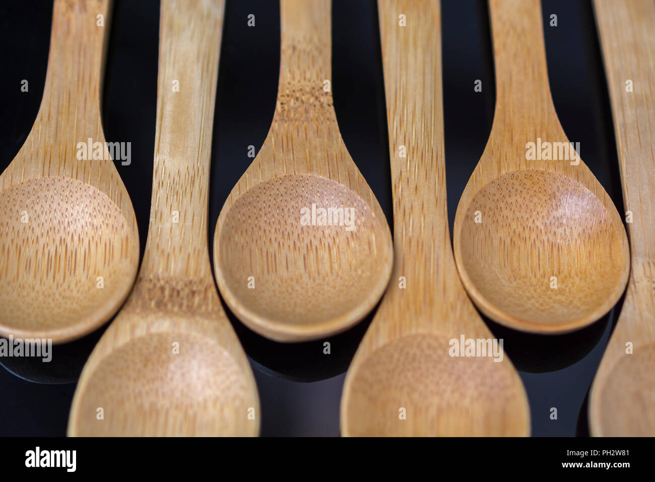 Carved bamboo spoons (teaspoon size) close ups. Metaphor food, also