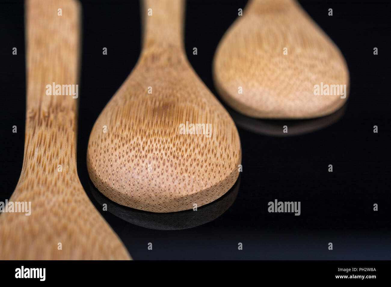 Carved bamboo spoons (teaspoon size) close ups. Metaphor food, also