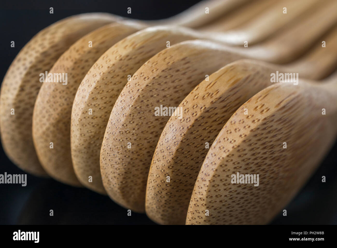 Carved bamboo spoons (teaspoon size) close ups. Metaphor food, also