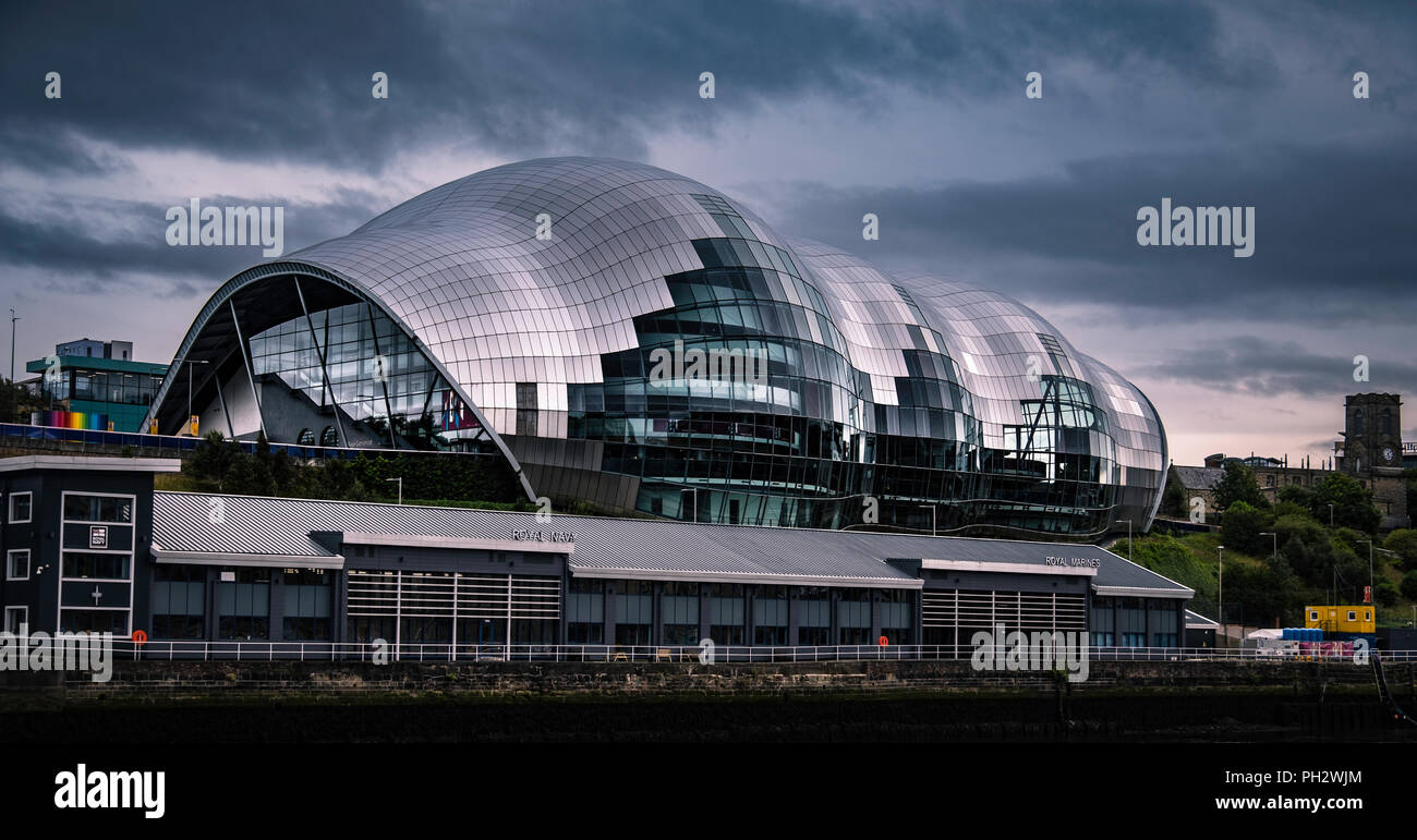 The Sage Gateshead above HMS Calliope which is the principal Royal Naval Reserve training unit for the North East of England. Stock Photo